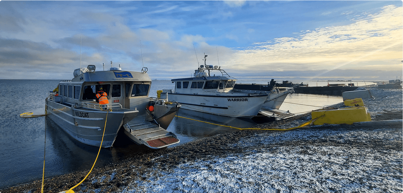 NML vessels docked at snowy Arctic shoreline